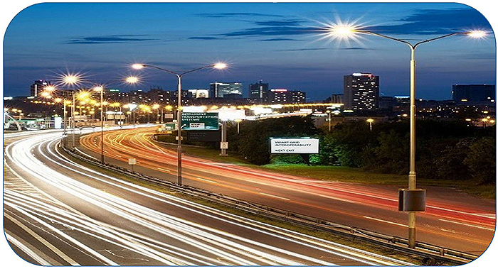 A time-lapse photo of a lighted highway with vehicular traffic.