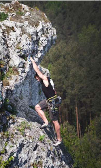 In the lower right of the slide is an image of a man rock climbing to demonstrate a major challenge