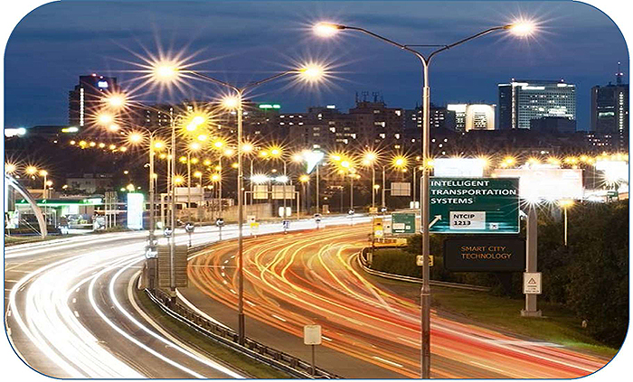 A time-lapse photo of a lighted highway with vehicular traffic.