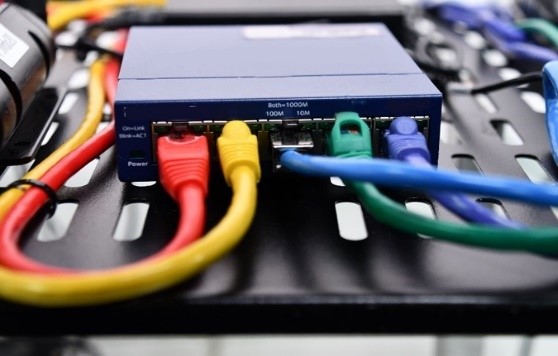 This photo shows the Ethernet switch in CAVe-in-a-box. Five wires of different colors are plugged into the Ethernet switch.