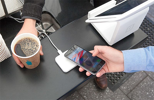 This is a photograph of Apple Pay being used to purchase a cup of coffee