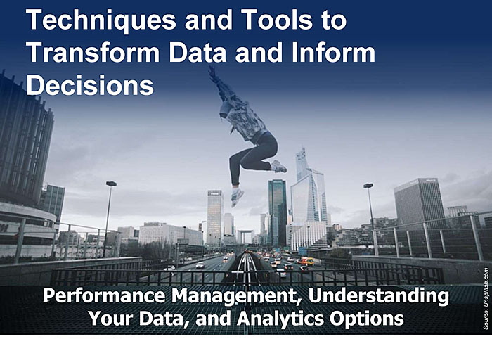 Slide graphic image with the text: Techniques and Tools to Transform Data and Inform Decisions. The background image is a stock photo of a dancer superimposed leaping above a walkway over a busy city roadway with a cityscape in the background.