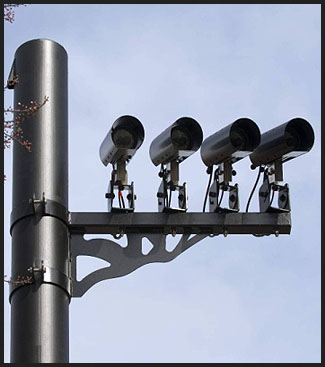 This is a photograph of four ALPR cameras attached to a tall pole.