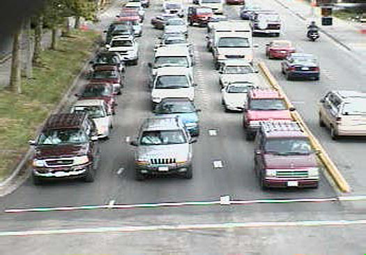 This is an example of images from a video camera sent through a Video Image Processing unit. In this picture, there are three lanes of cars waiting at an intersection.