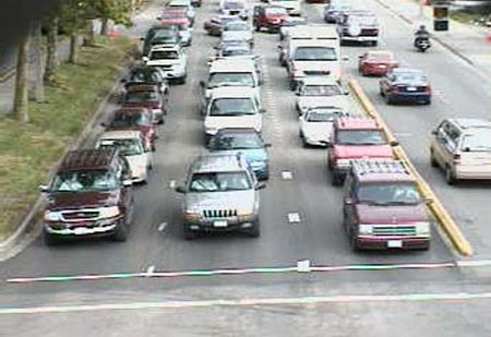 This is an example of images from a video camera sent through a Video Image Processing unit. In this picture, there are three lanes of cars waiting at an intersection. Source: Econolite