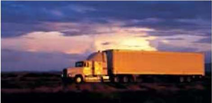 Stock photo of a commercial freight truck driving on a road