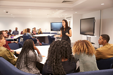 Photo of people and instructore in a seminar setting 