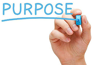 The lower right corner of this slide includes an image of a hand writing the word “Purpose” with a light blue marker.